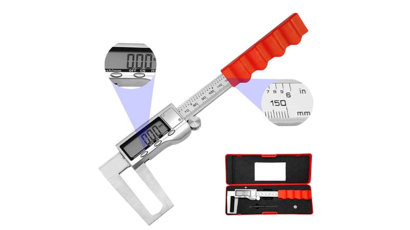 Dial caliper measuring brake rotor thickness during automotive inspection